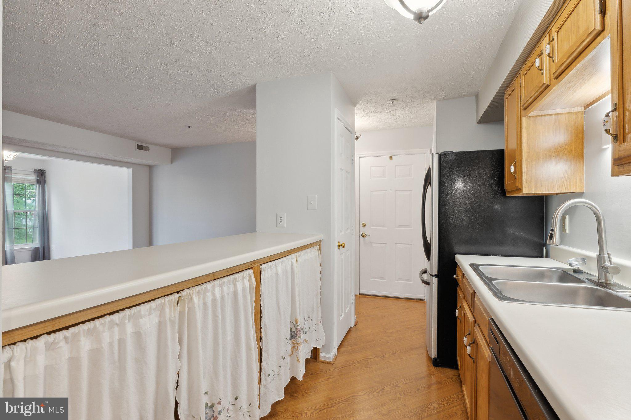 815 Deering Road, Unit 7H Pasadena, MD 21122 - Photo 7 of 24 a bathroom with a sink a mirror and a shower