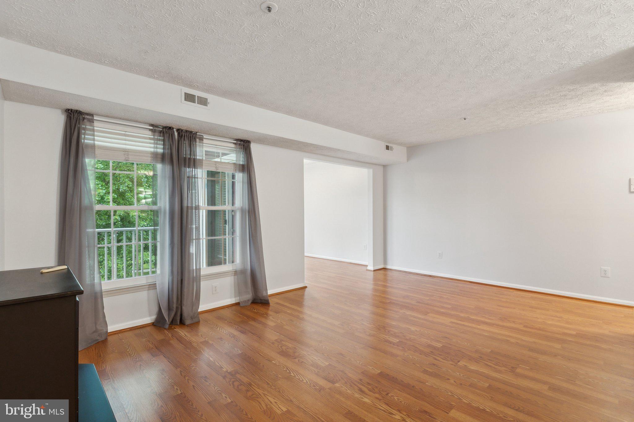 815 Deering Road, Unit 7H Pasadena, MD 21122 - Photo 9 of 24 wooden floor in an empty room with a window