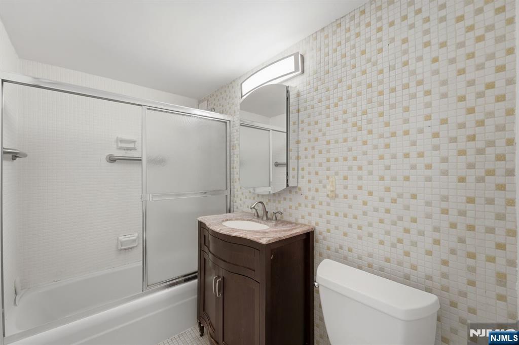 265 Main Street, Unit 704 Ridgefield Park, NJ 07660 - Photo 16 of 23 a bathroom with a sink toilet and shower