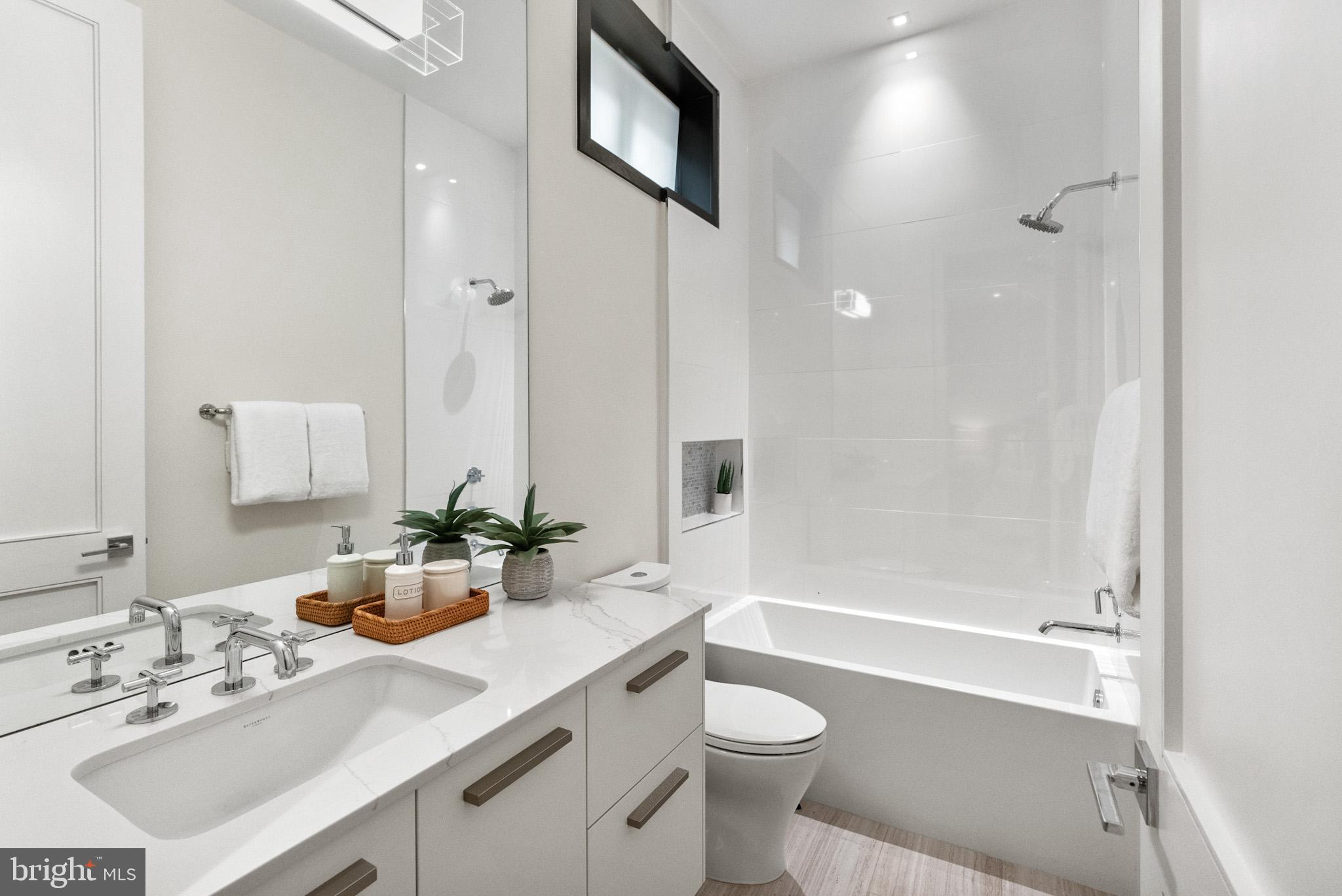 1310 Q Street Northwest, Unit 4 Washington, DC 20009 - Photo 15 of 24 a bathroom with a sink a toilet and shower