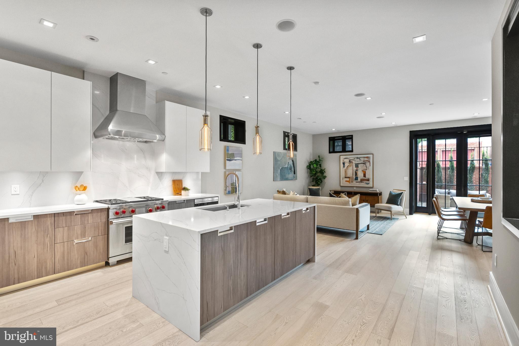1310 Q Street Northwest, Unit 4 Washington, DC 20009 - Photo 10 of 24 a kitchen with stainless steel appliances kitchen island a large island in the center
