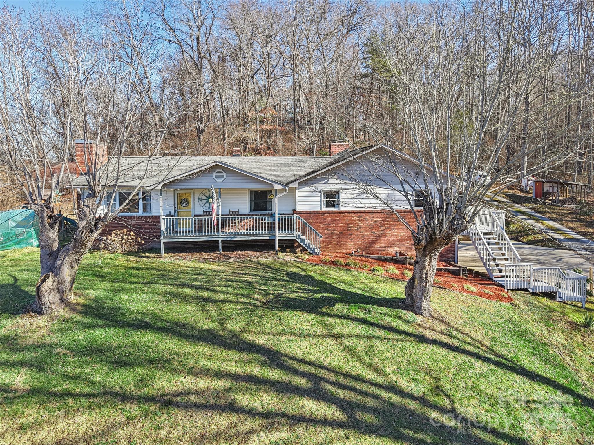 57 Bittersweet Trail Canton, NC 28716 - Photo 1 of 40 a front view of a house with garden
