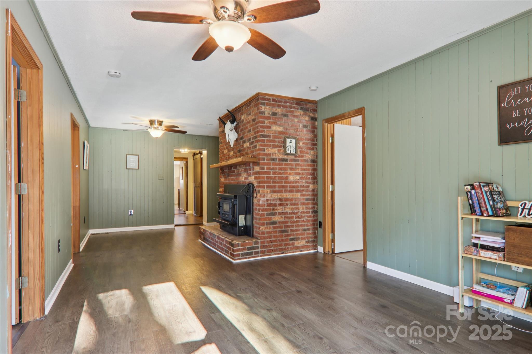 57 Bittersweet Trail Canton, NC 28716 - Photo 14 of 40 a view of an empty room with wooden floor and a window