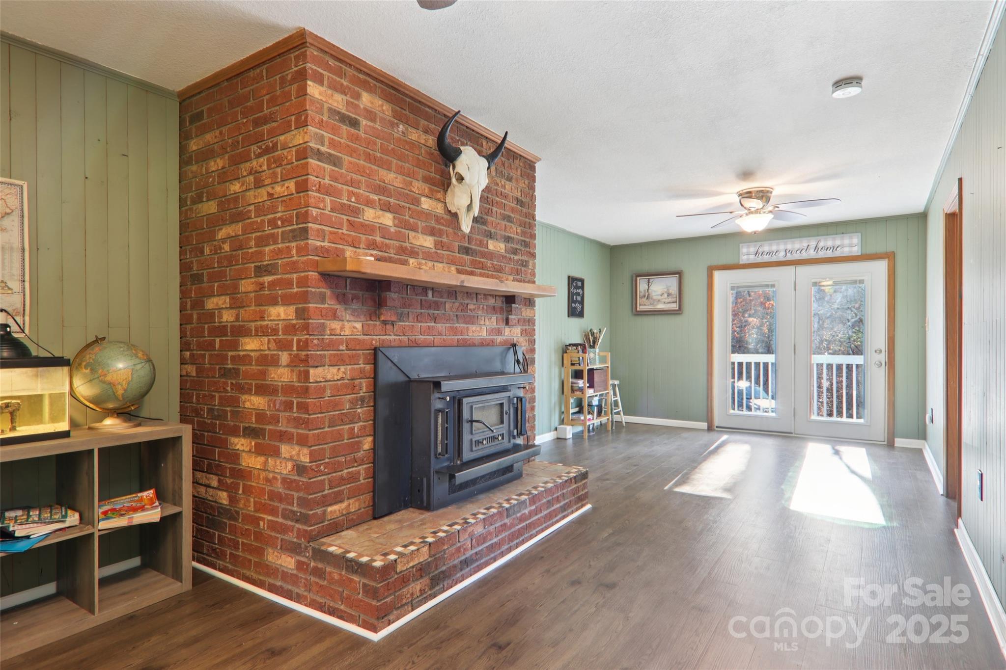 57 Bittersweet Trail Canton, NC 28716 - Photo 15 of 40 a living room with furniture a flat screen tv and a fireplace