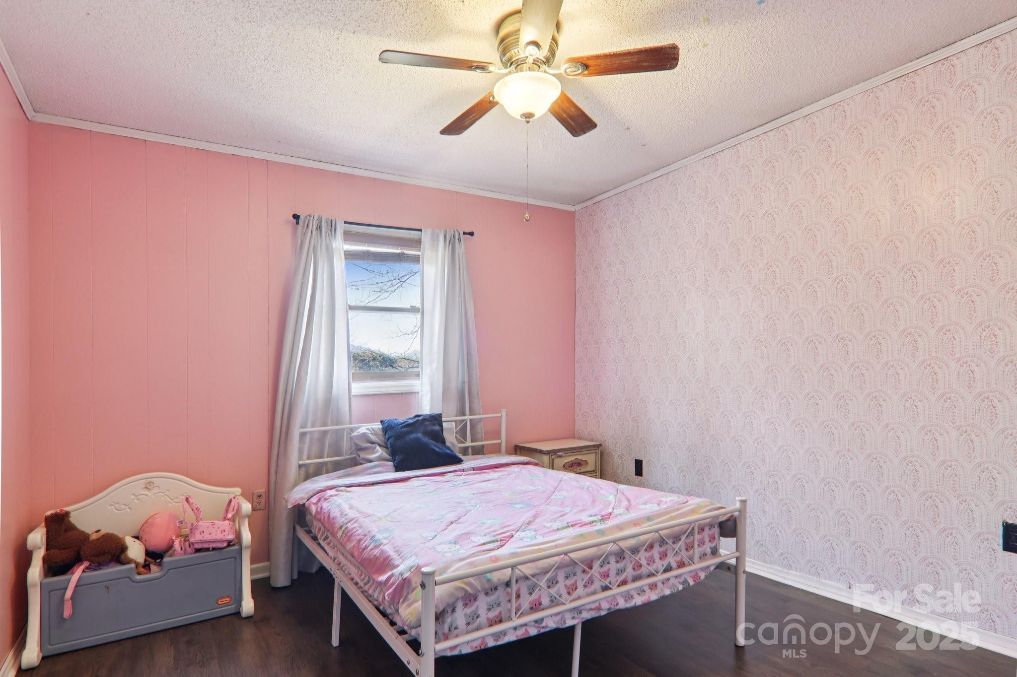 57 Bittersweet Trail Canton, NC 28716 - Photo 23 of 40 a bedroom with a bed and a chandelier fan