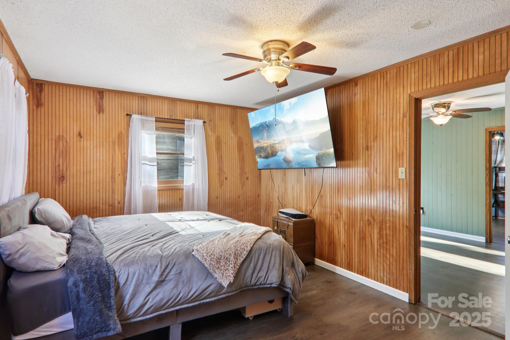 57 Bittersweet Trail Canton, NC 28716 - Photo 25 of 40 a bedroom with a bed and a chandelier