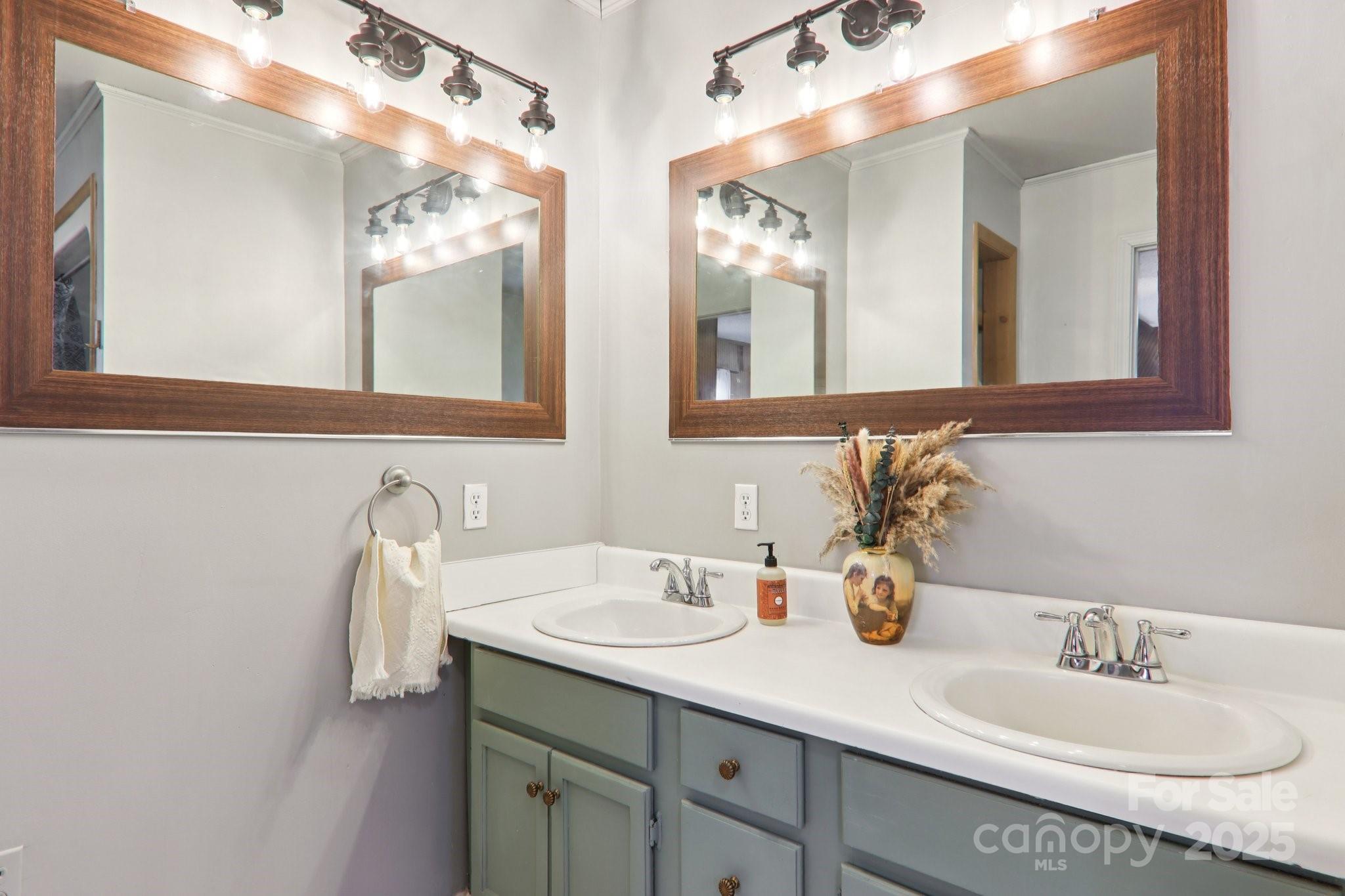 57 Bittersweet Trail Canton, NC 28716 - Photo 27 of 40 a bathroom with a double vanity sink and a mirror