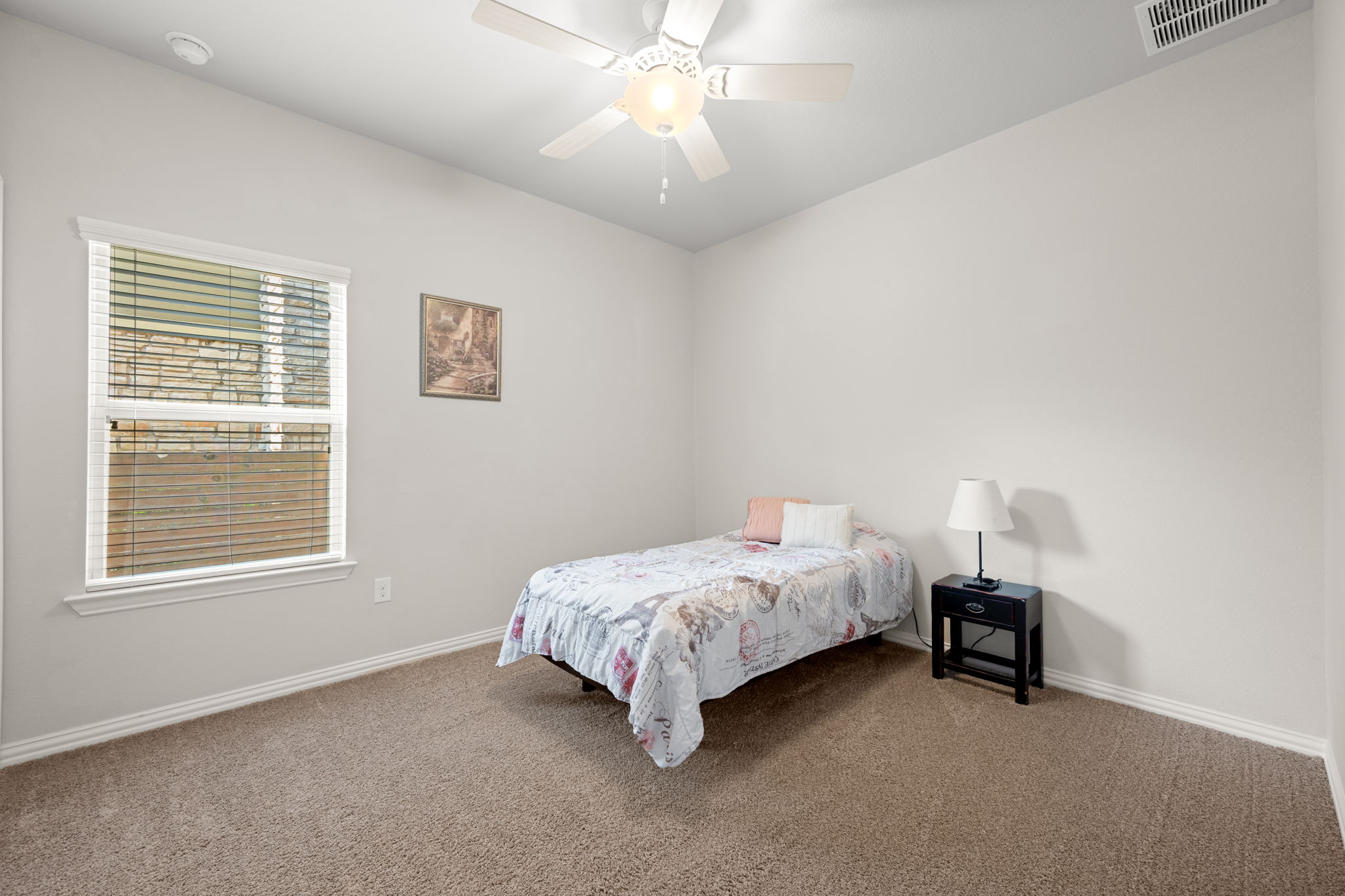 8800 Slater Drive Austin, TX 78747 - Photo 24 of 40 a room with a bed and a window