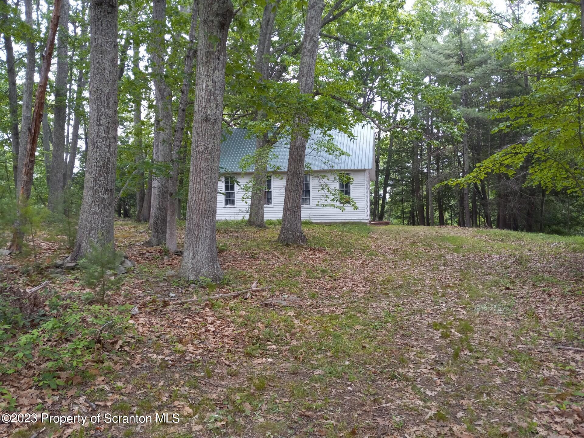 Mill Lane Tunkhannock, PA 18657 - Photo 5 of 6 a house with trees in front of it