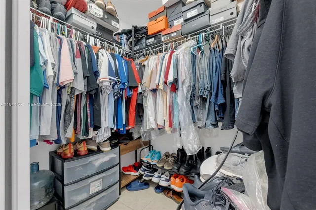 a view of walk in closet with clothes