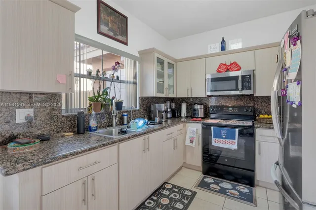 a kitchen with stainless steel appliances granite countertop a stove and a sink