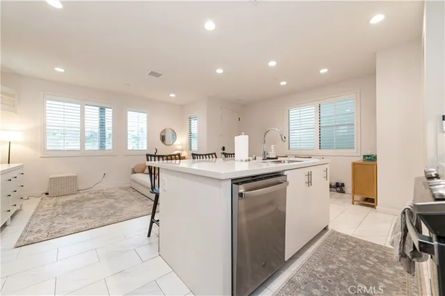 a view of a hallway with a livingroom and a bathroom