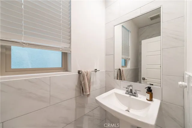 a living room with furniture a ceiling fan and a window