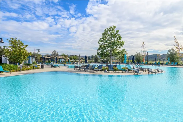 a view of swimming pool with outdoor seating and city view