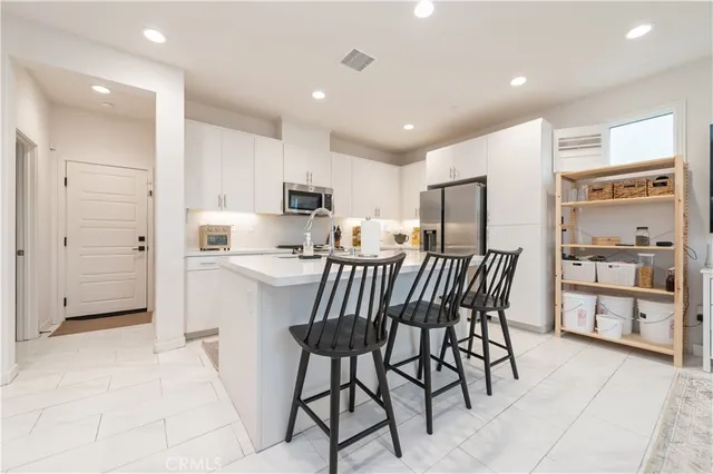 a kitchen with a sink cabinets and stainless steel appliances