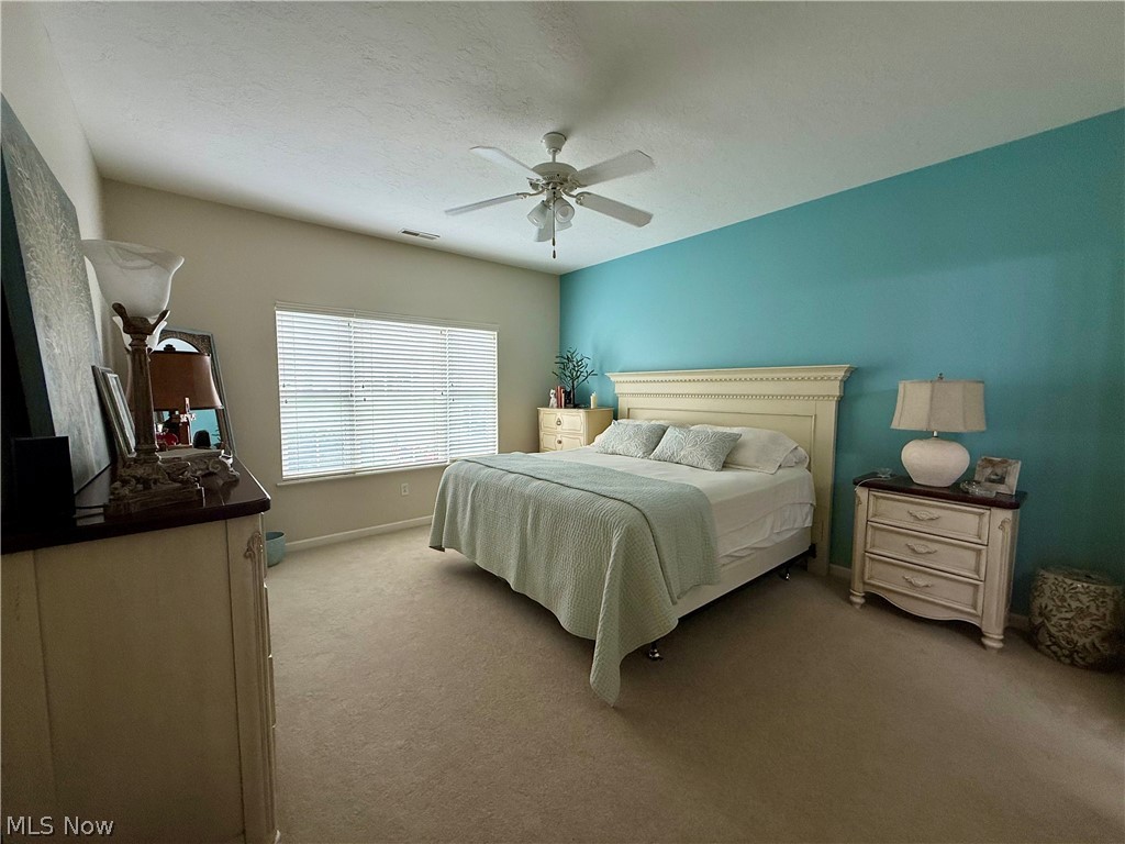 302 Wilcox Road Youngstown, OH 44515 - Photo 14 of 30 Vaulted ceiling, ceiling fan, expansive window with blinds, and neutral carpeting