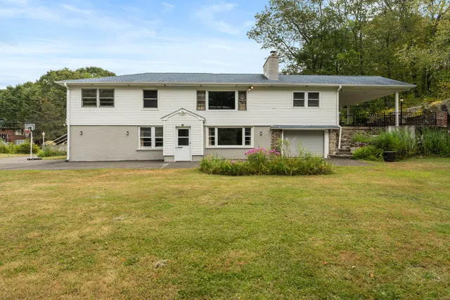 a front view of house with yard and green space
