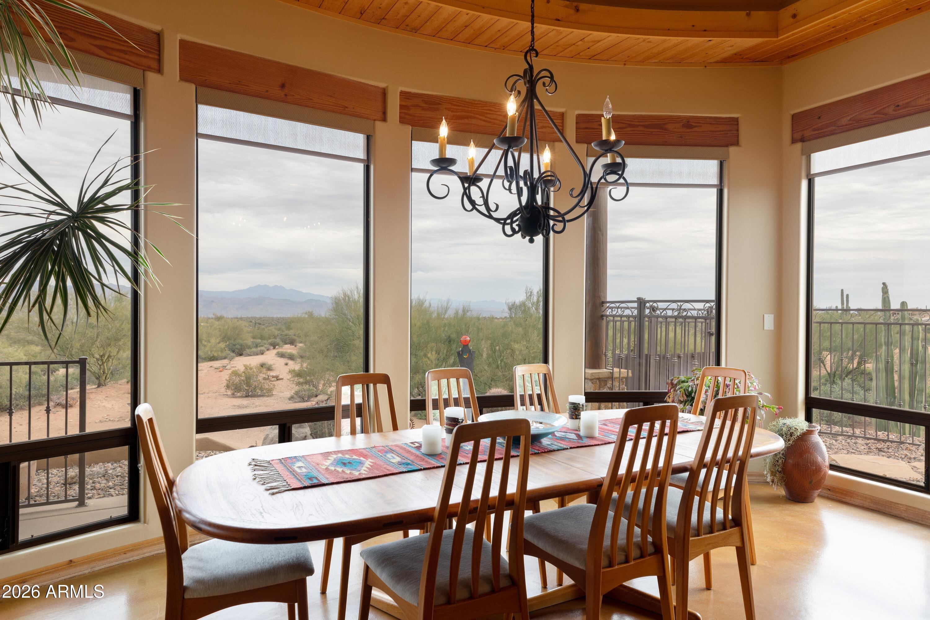 13906 East Montello Road Scottsdale, AZ 85262 - Photo 29 of 110 a view of a dining room with furniture large windows and wooden floor