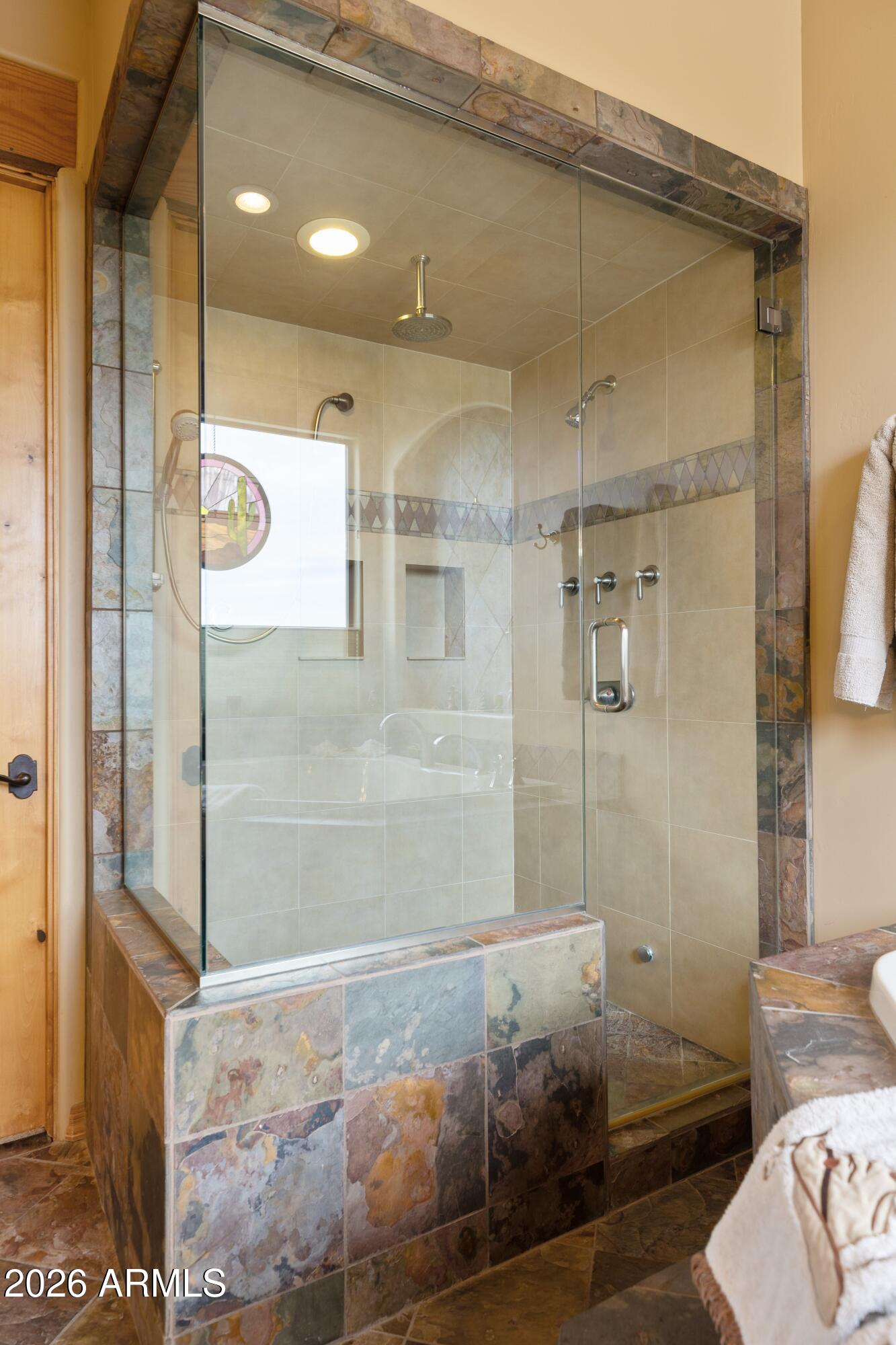 13906 East Montello Road Scottsdale, AZ 85262 - Photo 33 of 110 a bathroom with a glass shower door and a sink