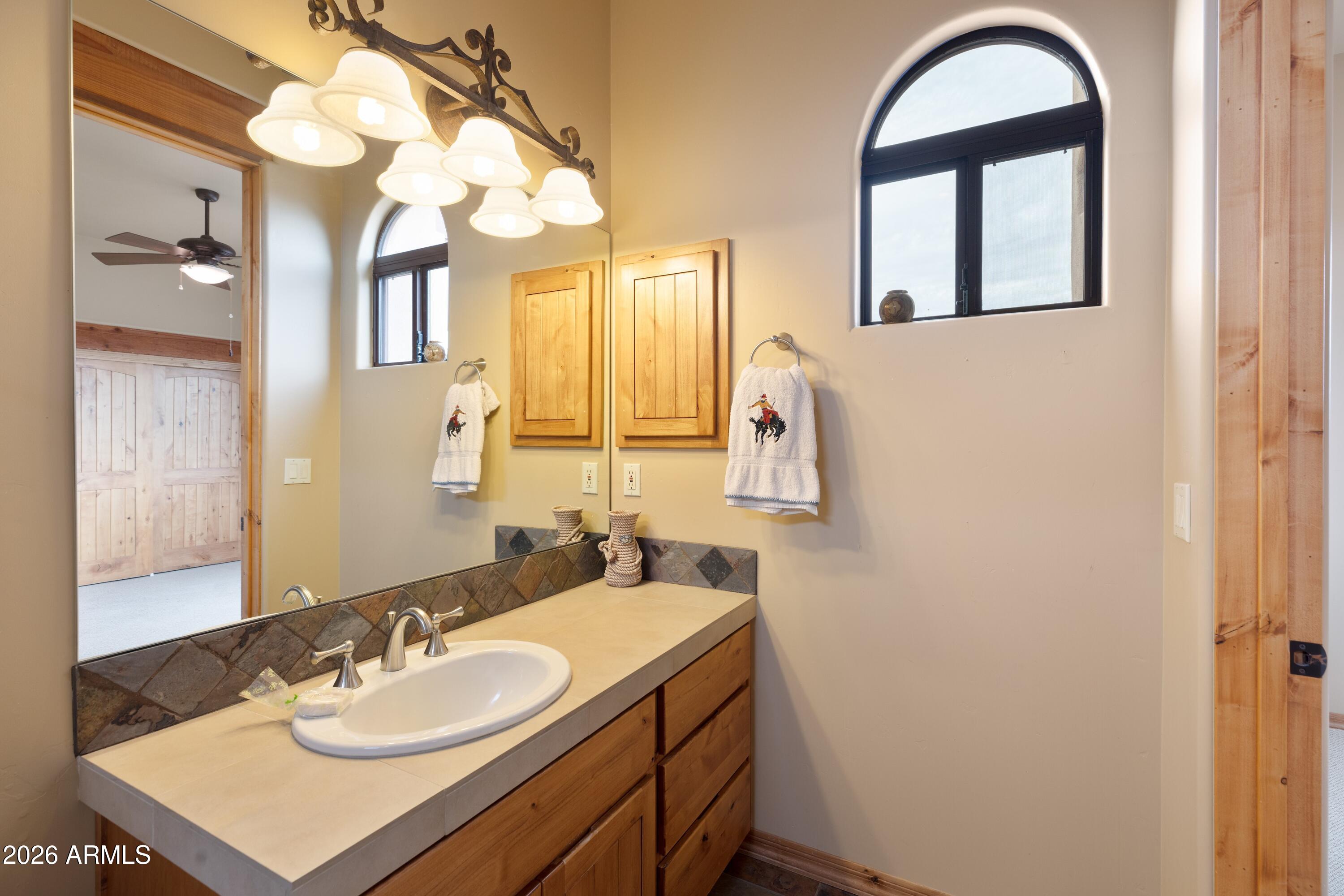 13906 East Montello Road Scottsdale, AZ 85262 - Photo 37 of 110 a bathroom with a sink vanity and a mirror