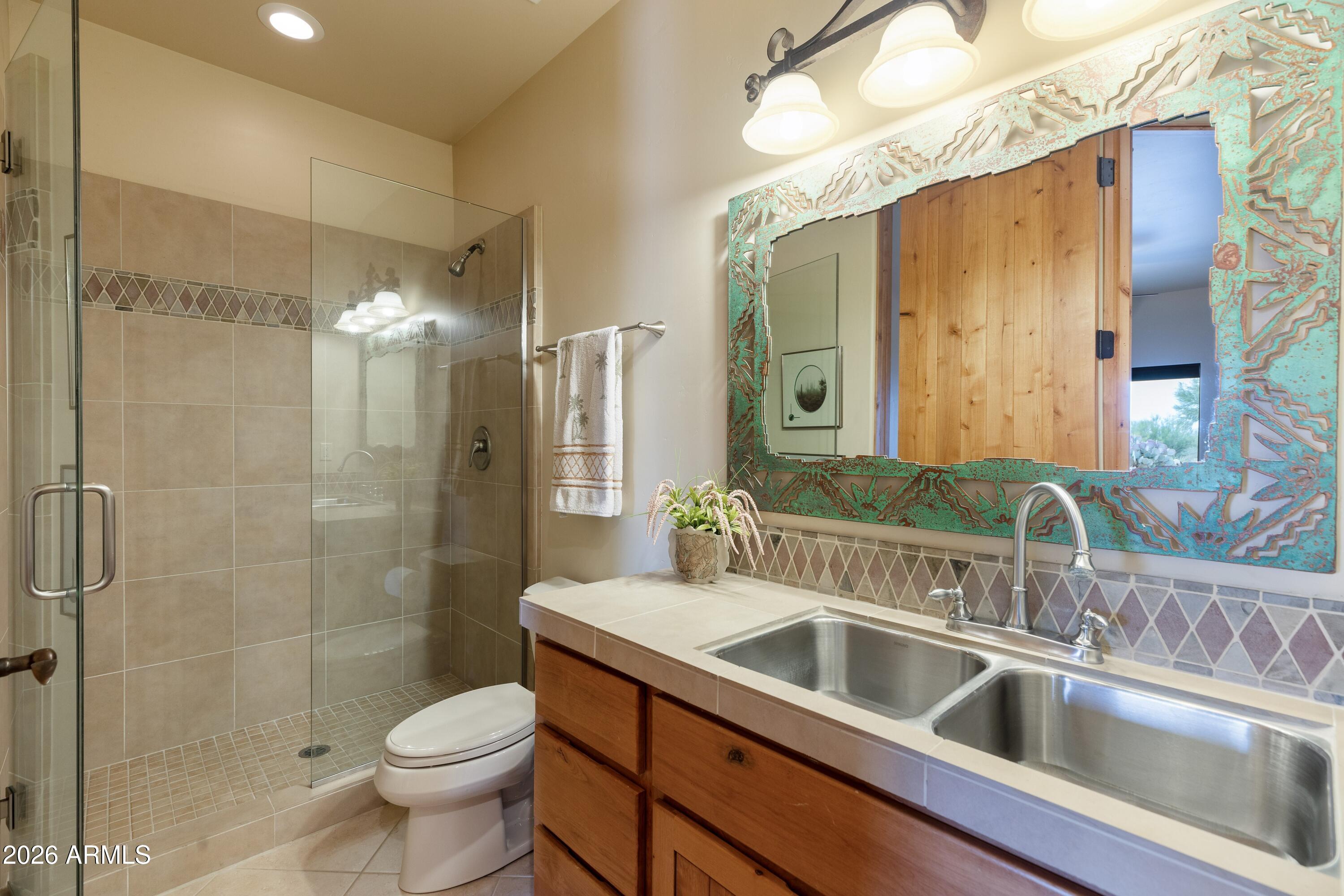 13906 East Montello Road Scottsdale, AZ 85262 - Photo 45 of 110 a bathroom with a double vanity sink toilet and shower