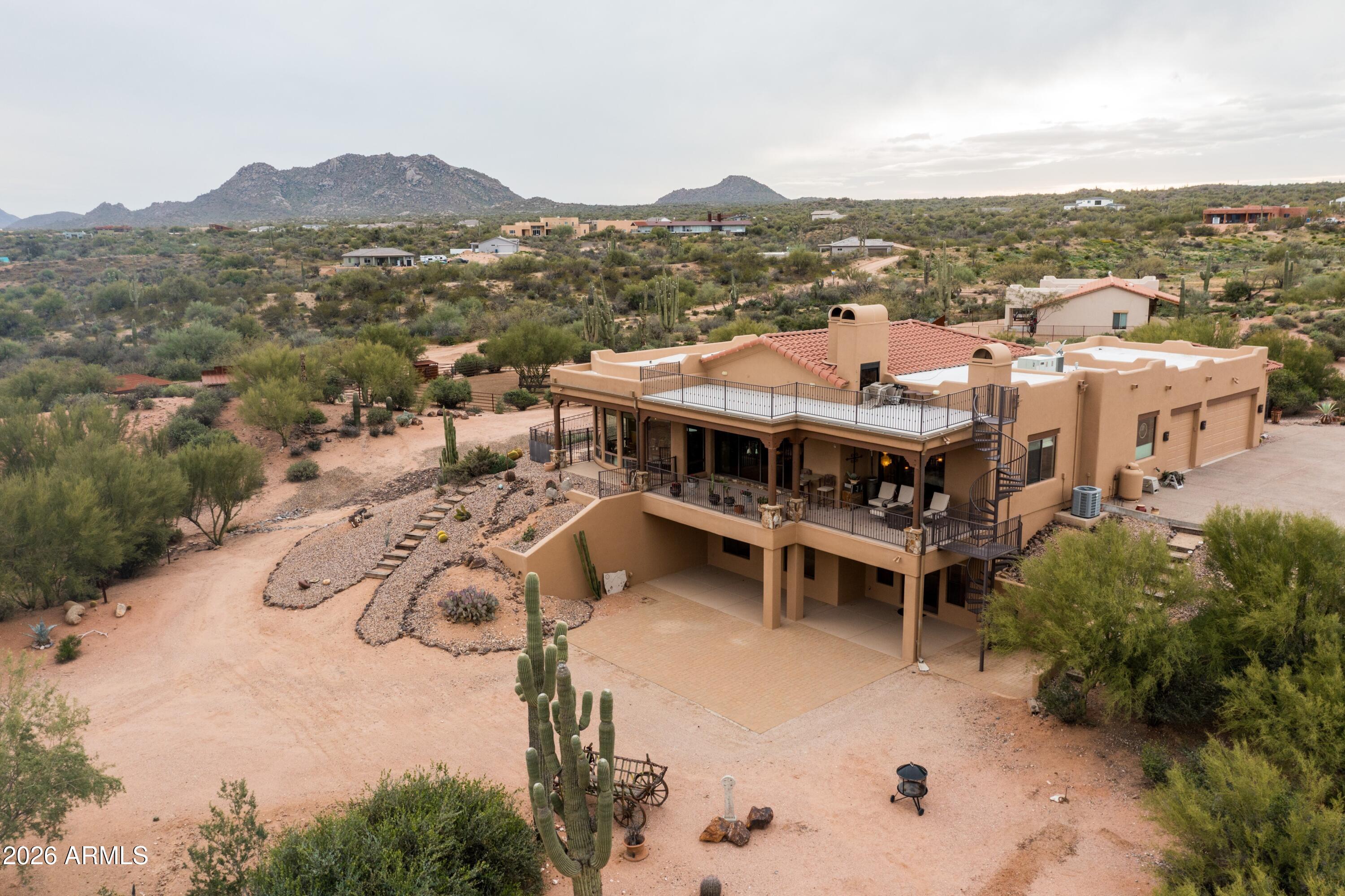 13906 East Montello Road Scottsdale, AZ 85262 - Photo 93 of 110 an aerial view of a house with a mountain in the background