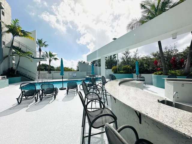 a view of a patio with a table and chairs and potted plants