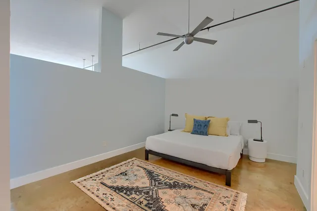 a bedroom with a bed and a rug