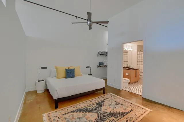 a bedroom with a bed and wooden floor