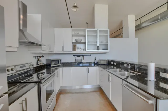 a kitchen with a sink stove and cabinets