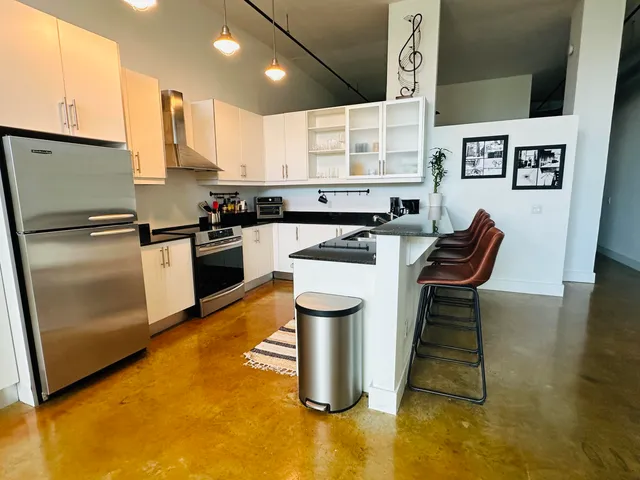 a kitchen with a sink appliances and cabinets