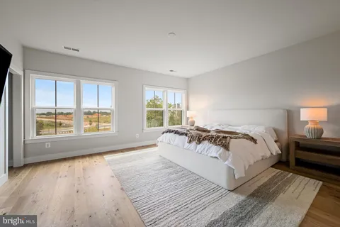 a spacious bedroom with a large bed and a large window