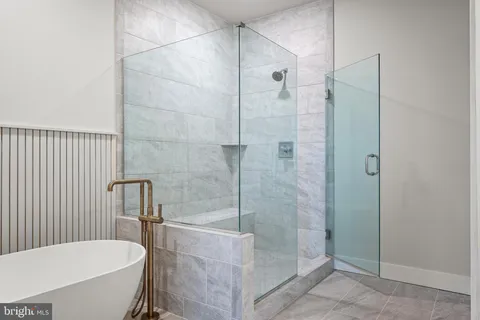 a bathroom with a bathtub and shower