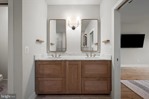 a bathroom with mirror and