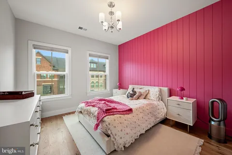 a bedroom with a bed next to a window