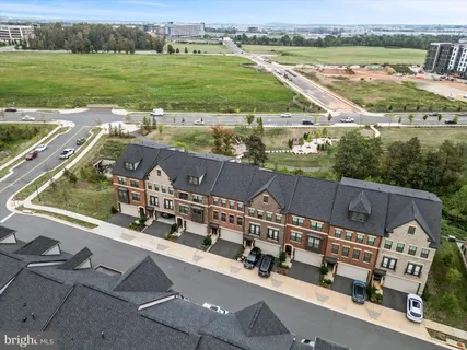 an aerial view of a house with a garden and lake view