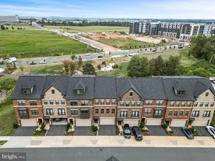 an aerial view of a house with a garden and lake view