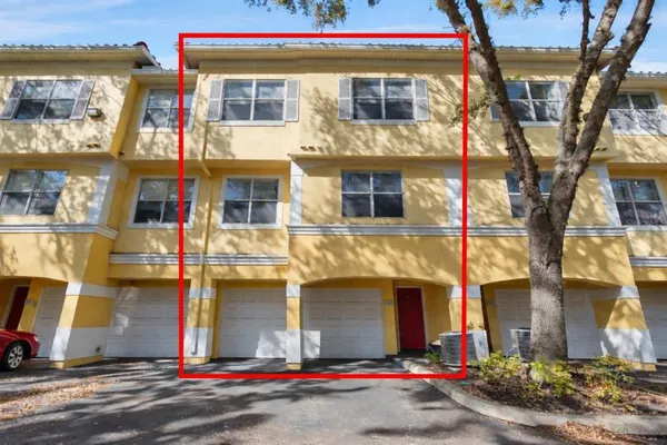a view of empty room with wooden floor and ceiling fan