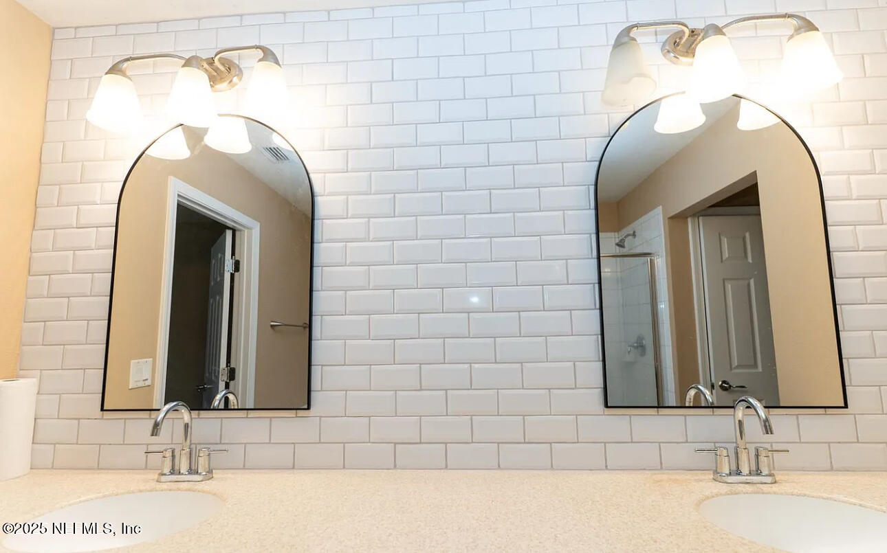 4204 Metron Drive Jacksonville, FL 32216 - Photo 12 of 24 a bathroom with a sink and a mirror