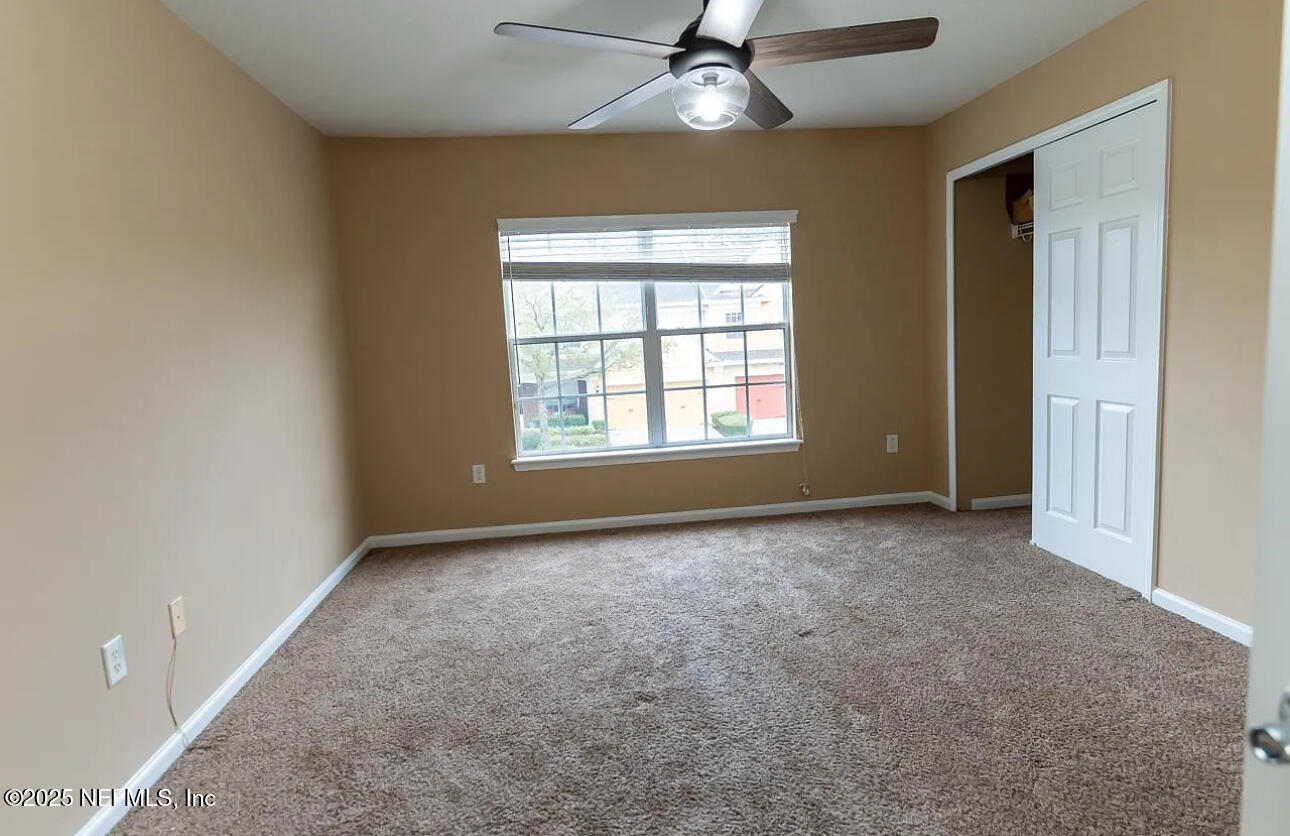 4204 Metron Drive Jacksonville, FL 32216 - Photo 18 of 24 an empty room with windows and fan