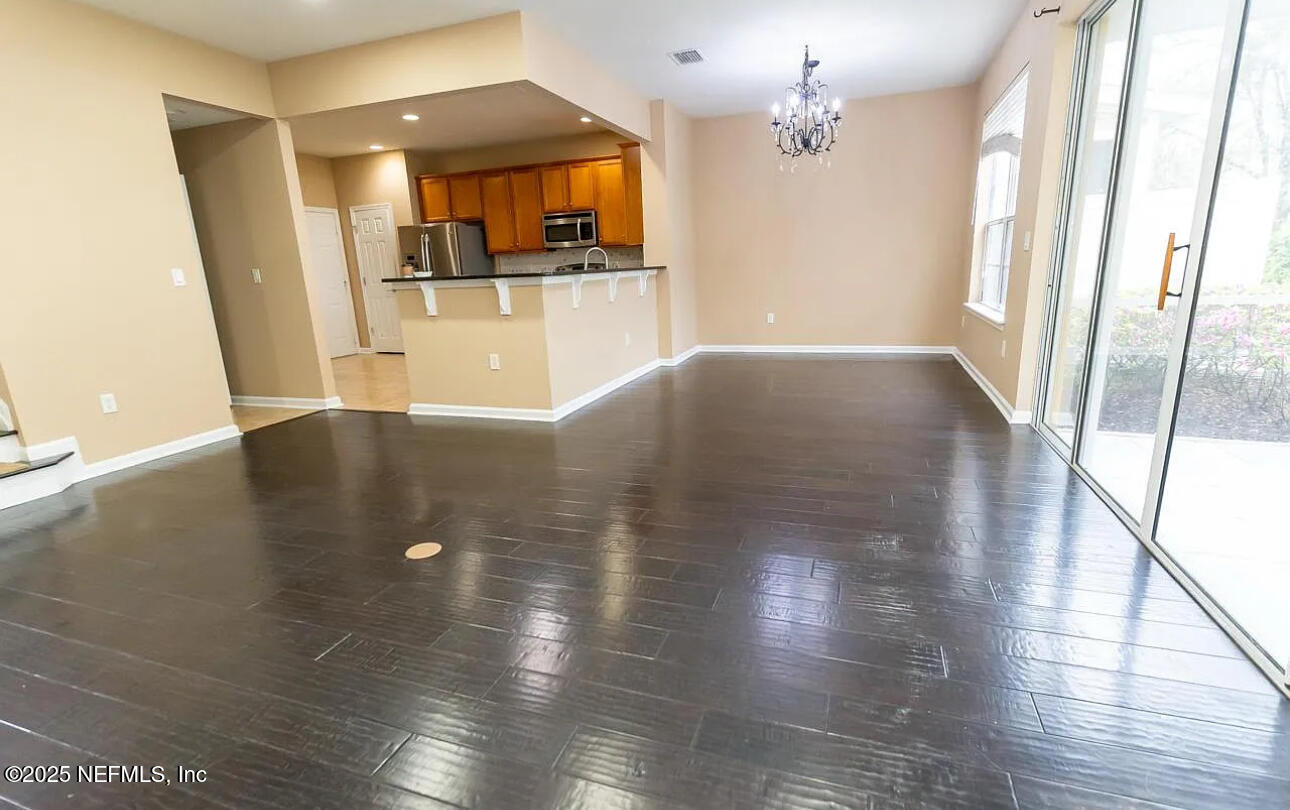4204 Metron Drive Jacksonville, FL 32216 - Photo 5 of 24 a view of a living room with hardwood floor and a ceiling fan