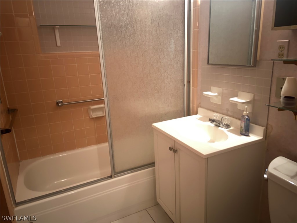 119 Apache Street Lehigh Acres, FL 33936 - Photo 11 of 29 a bathroom with a sink a toilet and shower