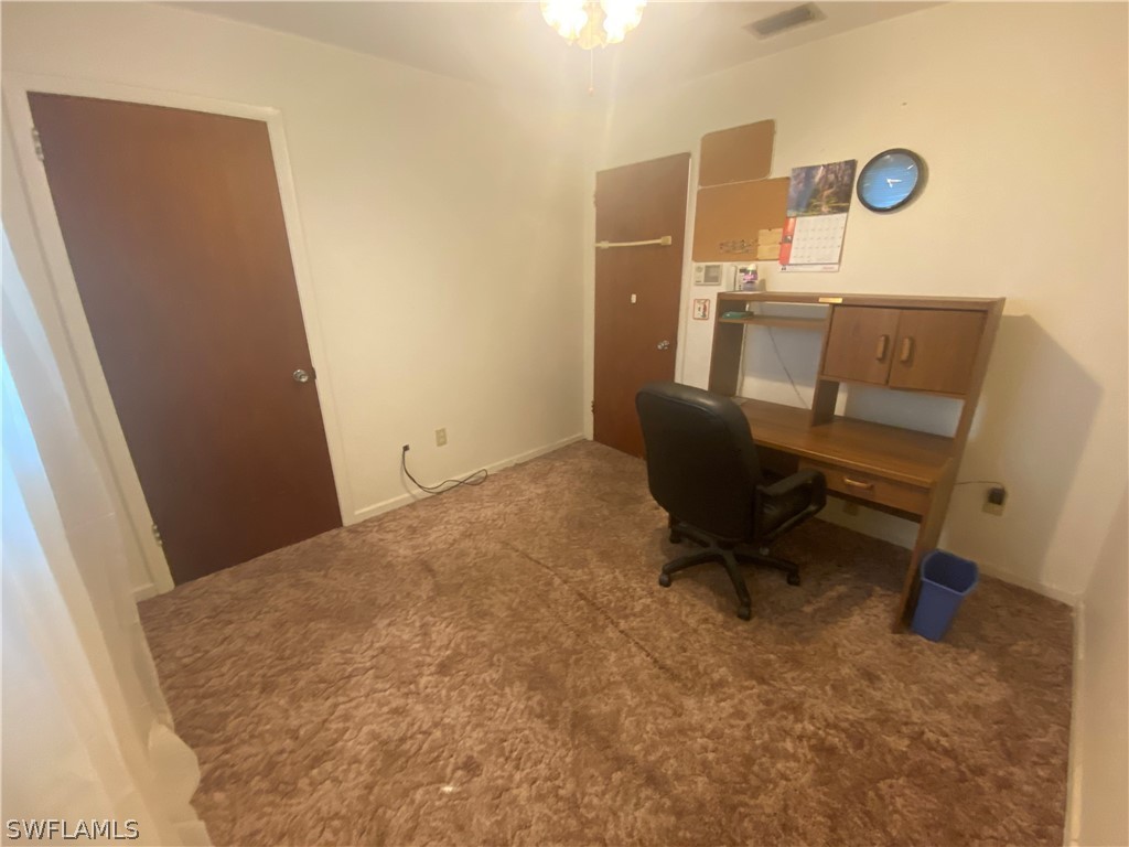 119 Apache Street Lehigh Acres, FL 33936 - Photo 20 of 29 a workspace room with a chair