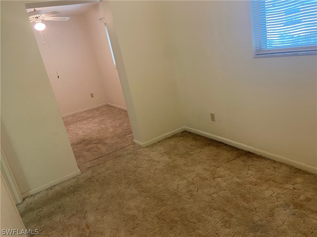 119 Apache Street Lehigh Acres, FL 33936 - Photo 23 of 29 an empty room with a hallway