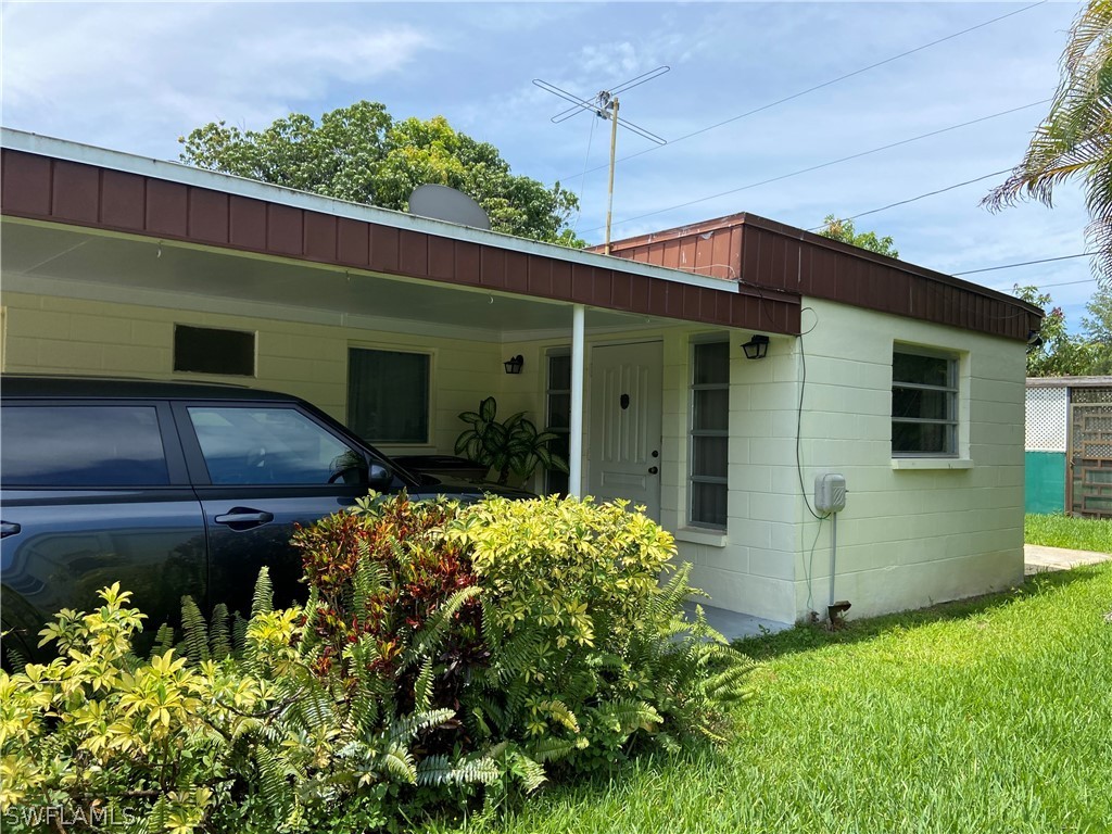 119 Apache Street Lehigh Acres, FL 33936 - Photo 6 of 29 a front view of a house with a yard