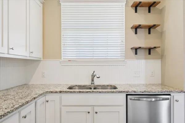 a kitchen with granite countertop white cabinets and a granite counter tops