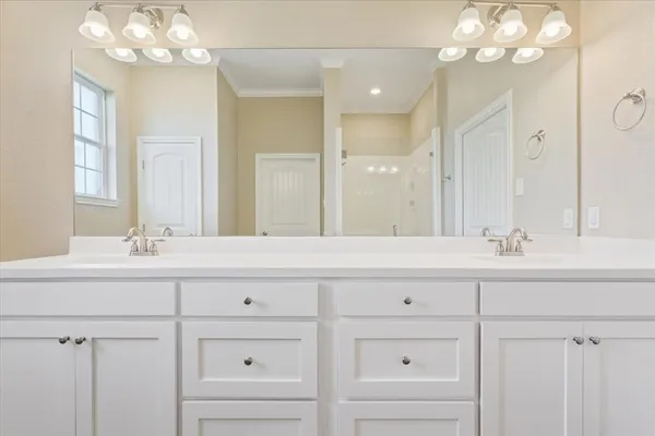 a bathroom with a sink vanity and a mirror