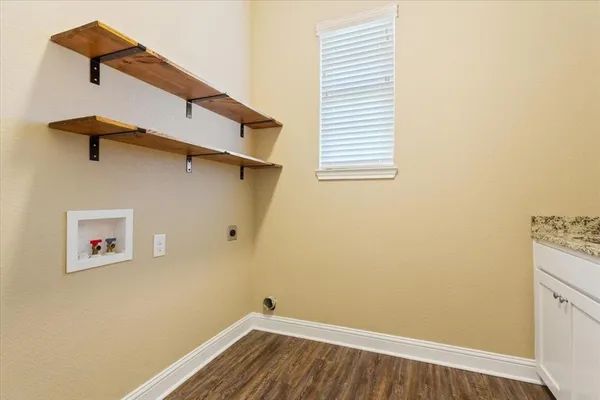a view of a room with wooden floor and a window