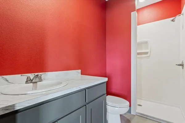a bathroom with a sink a toilet and a mirror