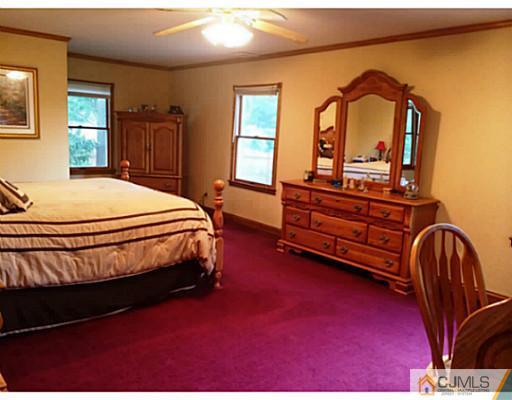 8 Winant Road Kendall Park, NJ 08824 - Photo 8 of 23 a bed sitting in a bedroom next to a window